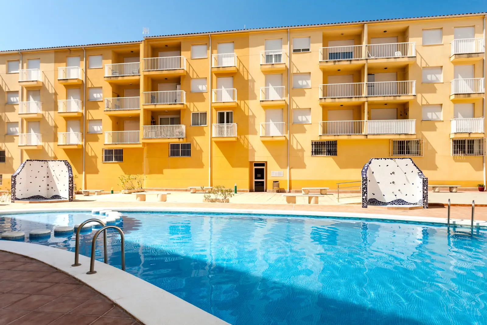 Piscina compartida y fachada de los apartamentos Mare Nostrum, en el centro de Alcossebre